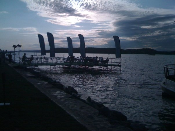 Lakeside festival platform with flags on Lake Balaton at dusk